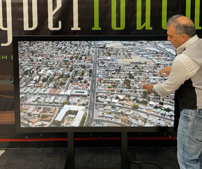 Man using an interactive touchscreen display in a modern New Orleans business environment